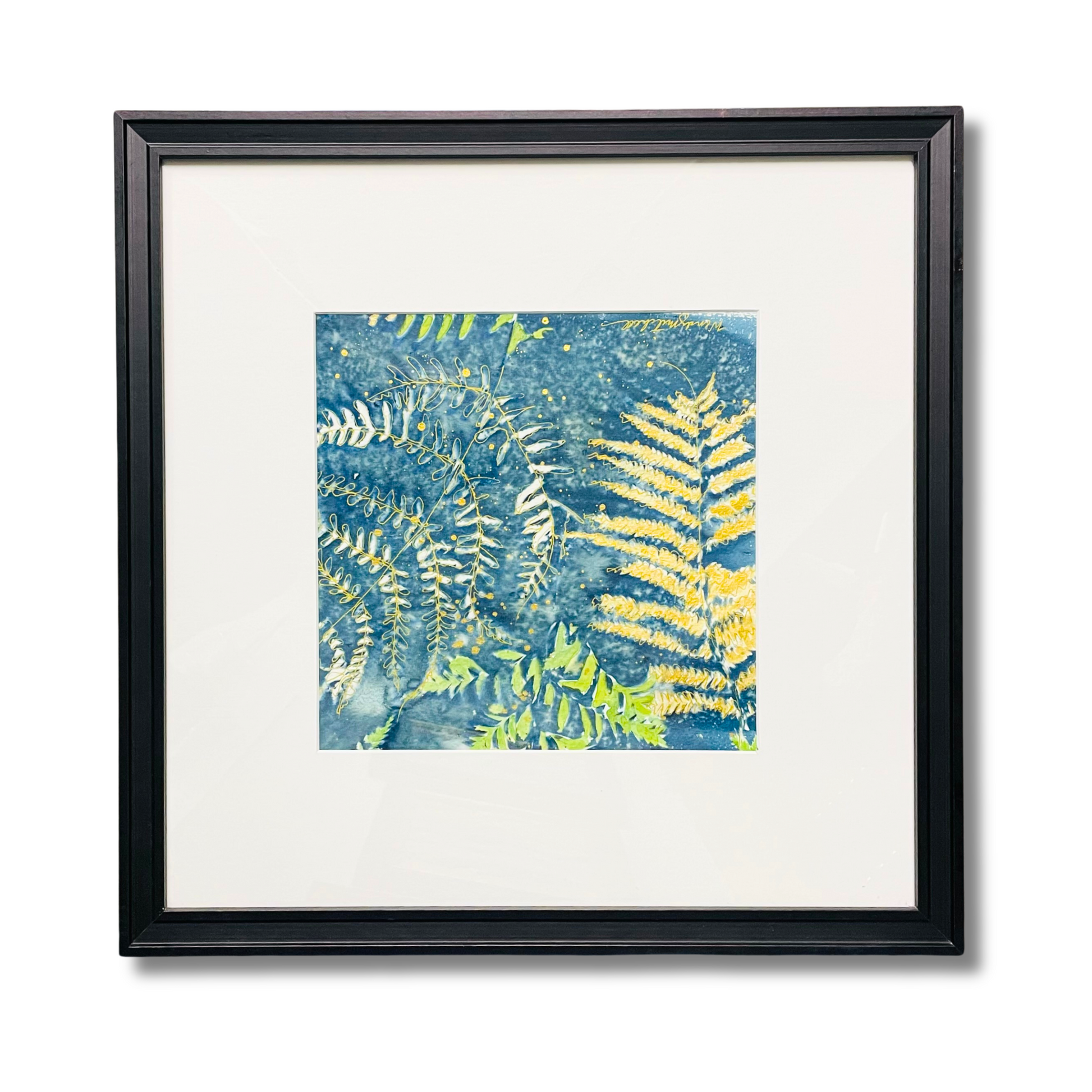 Framed botanical art print featuring yellow and green fern leaves on a textured blue background, presented in a black frame with a white mat board.