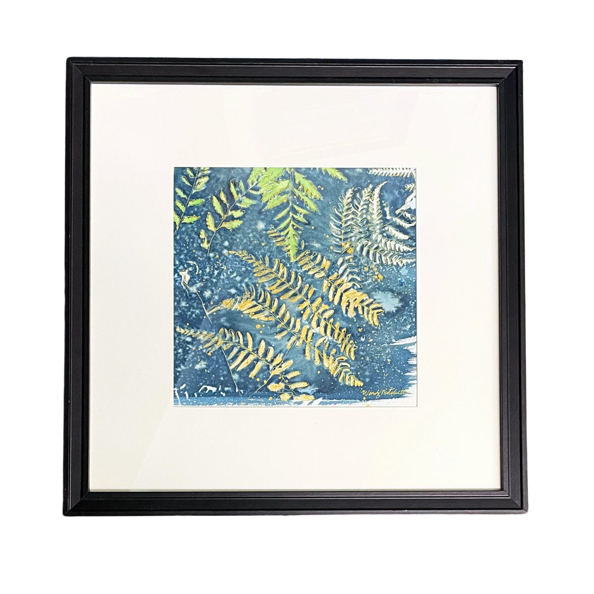 Framed square art print featuring a blue and green fern pattern, set in a white mat and a black frame against a white background.